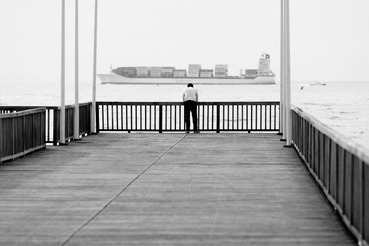 Lonely man on the wooden pier peering at a cargo - France/Normandy - Le Havre - November 2009 - Black & White